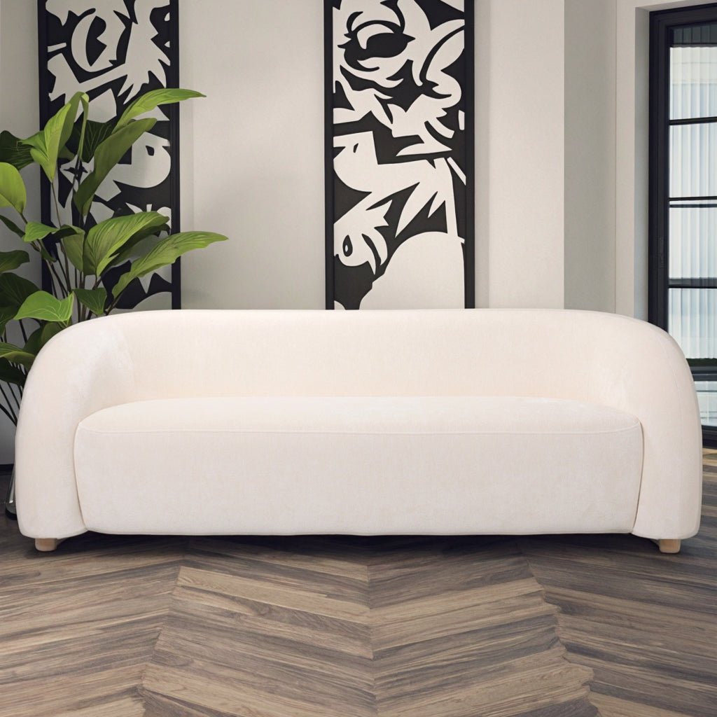 ספת “Olivia” לבנה בעיצוב עגלגל בחלל מודרני